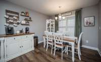 Roomy dining area with room for a sideboard, table and chairs and a corner hutch - or two! Big window looks out on the screened porch overlooking your large fenced yard.