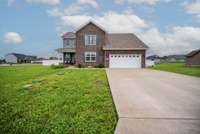 This immaculate home is better than new, with a huge fenced in backyard on a corner lot.