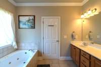 Primary bath with separate jetted tub and shower and dual sinks