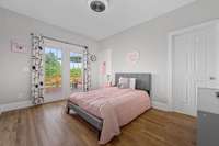 The second bedroom on the main level with doors to the patio and a jack and jill bathroom.