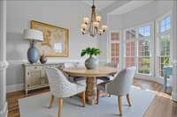 The dining room is surrounded by windows. Virtually staged.