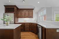 Pristine renovated kitchen with quartz countertops.