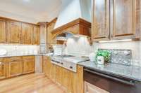Custom stove hood vent tops the gas range.