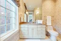 Ensuite bath with glass walled shower.
