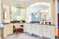 Ample cabinetry and room. Separate vanities, with this one offering a dressing table for makeup/hair.
