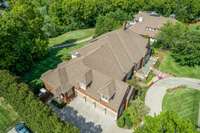 The ariel view shows the impressive main level living and size of the home, as well as the estate-sized Governors Club lot.  The home boasts a 4 car garage with additional parking and a circular driveway.