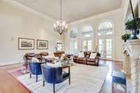 The impressive Great Room is spacious, with arched windows that hang over sets of doors opening to the back terrace. The wood flooring continues through to the kitchen.