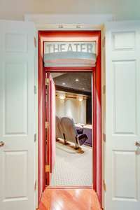 Located steps away from your billiard room is the home theater.  No home theater is complete without your own personal snack bar! This one has a sink, refrigerator, soda gun, neon sign and candy display.