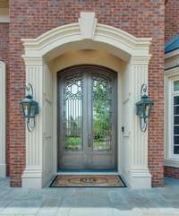 Dual gaslit lanterns compliment your new home's grand entry with double iron front doors.