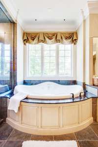 The deep soaking tub is jetted.