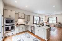 Cabinetry has granite counter tops and built in range with cooktop~