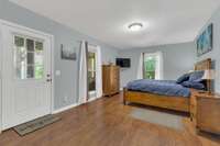 Lower level lake view bedroom with private entrance and direct access to screened in porch and hot tub patio