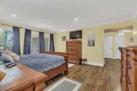 Primary lake view suite with doors leading to wraparound lake view deck