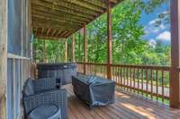 Lower screened in lake view porch and additional covered lake view hot tub patio overlooking the lake