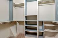 The primary bedroom has 2 closets, one has added built in shelves.