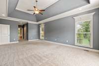 Very large primary bedroom with tray ceiling