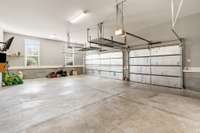 Three car attached garage with extra high ceiling.