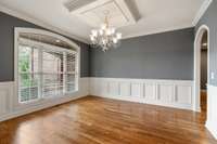 Formal dining room at the front of the home with gorgeous wainscoting