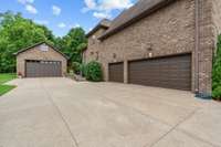Side view of the home, plenty of storage with the 3 car attached garage and an additional detached garage.