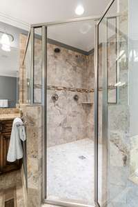 Primary Bathroom tile shower with dual shower heads.