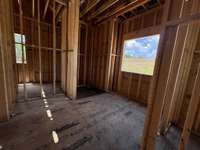 Primary Spa with free-standing tub, large shower, two vanities connecting to two primary closets and laundry room! *this house is under construction. Photo taken 6/22/25