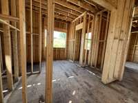 Primary Spa with free-standing tub, large shower, two vanities connecting to two primary closets and laundry room! *this house is under construction. Photo taken 6/22/25