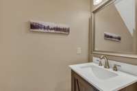 The Powder Room, just off the Den, has a newer vanity.