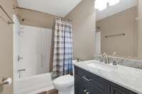 Full bath in secondary bedroom has handsome and functional vanity.