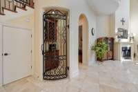 The iron doored wine alcove, with entry to the primary suite to the right, and under stairs storage to the left!