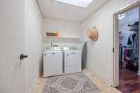 This Laundry room, easily accessible from the garage, foyer AND primary bedroom, is a concrete and steel reinforced storm shelter with HEAVY metal doors. Your storm worries are gone in this room!