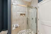 Primary bath tiled shower with bench
