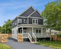 Enjoy your morning coffee on this covered front porch with your neighbors.  May a porch swing and a great book
