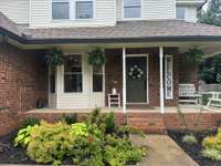 Generous front porch area offers plenty of room for rocking chairs.