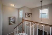 The stair way and upstairs hall is full of natural light.