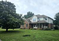This home is on a beautiful, level lot with mature trees all around. Look at that lovely Magnolia in bloom!