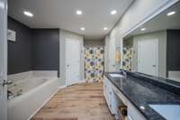 The Primary Bath has been newly updated. Two walk-in closets flank the jacuzzi tub.