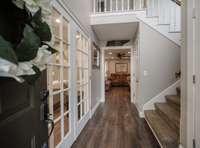 Entry way leads towards the office/formal dining room to the left, living area straight ahead and upstairs to the right.