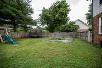 The back yard is nice and level, perfect for playing, practicing sports or gardening.