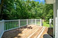 Enjoy a spacious rear deck, perfect for private relaxation or entertaining guests in a comfortable outdoor setting.
