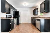 Spacious kitchen with ample counter space and a pantry for extra storage.
