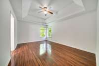 The master bedroom features beautiful tray ceilings, adding an elegant touch.