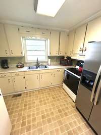 Open kitchen design with appliances staying.
