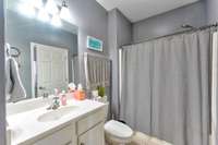 Guest bath with door to hall and second bedroom.