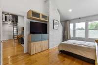 Exposed fireplace brick is a beautiful feature of this room.