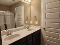 Custom Cabinets and Double Sinks in the Owner's Suite.   Picture of Previous House.