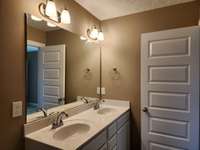 Primary Bath features 2 Sinks and Extra Storage in the Cabinets. Picture of Previous House.