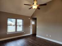 Living Room with Vaulted Ceiling and Ceiling Fan. Previous House is pictured.