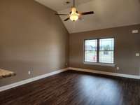 Spacious Living Room with Plank Flooring & Vaulted Ceiling.  Picture of Previous House.