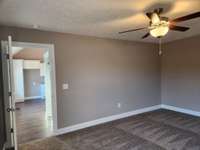 Extra Wall Space and Ceiling Fan in the Primary Bedroom.  Picture of Previous House.