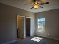 Owner's Suite on Main Level with Walk-In Closet.  Picture of Previous House.